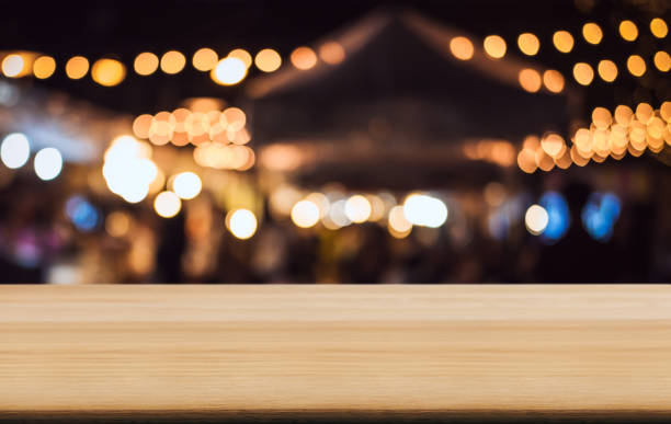istock Empty wooden table in front of abstract blurred festive background with light spots and bokeh for product montage display of product 1057614770
