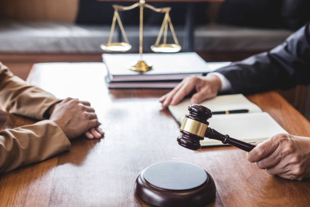 Businesswoman and Male lawyer or judge consult having team meeting with client, Law and Legal services concept stock photo