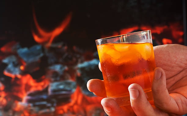 istock glass of drink in his hand 105761679