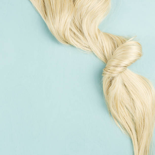 istock Hair extensions on blue wooden background. Top view 1057619914