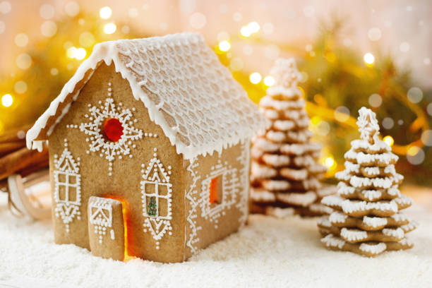 istock Gingerbread house and Christmas trees on a luminous background. Bokeh effect. 1057621704