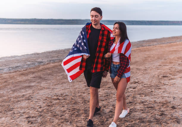istock oung couple on the beach walking together 1057623576
