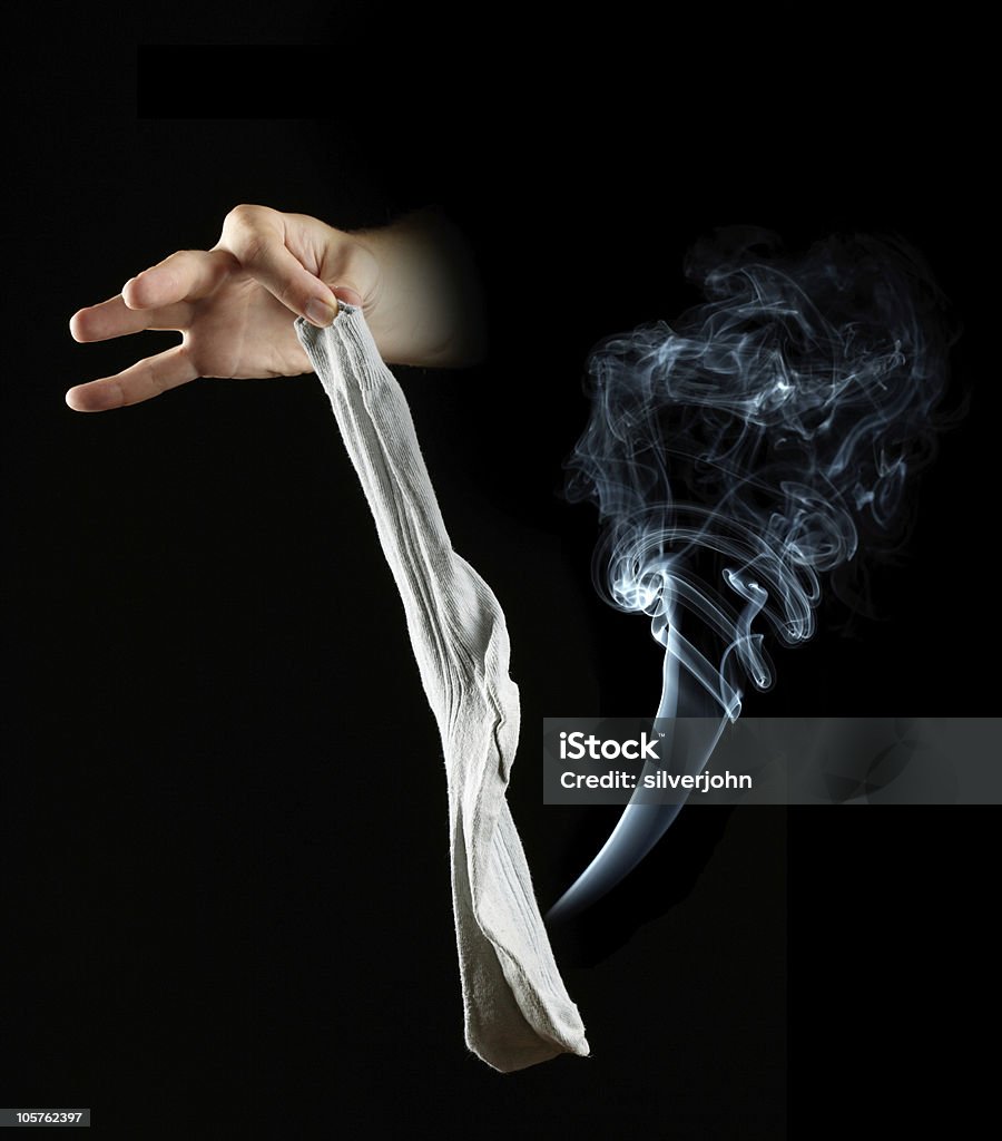 Ręka trzymająca stinky skarpetka na czarnym tle - Zbiór zdjęć royalty-free (Bawełna)