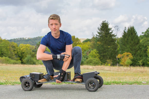 Dutch boy driving electric mountainboard in nature