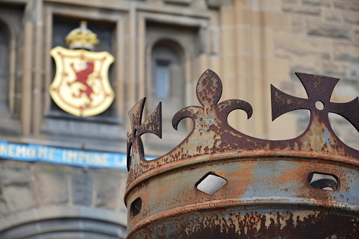 Crown in front of gate to Edinburgh Castle, Royal Stuart coat of arms in background, Scotland, United Kingdom, sunny day