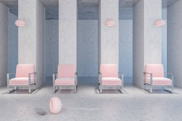 istock Pastel pink armchairs in a concrete room 1057630198