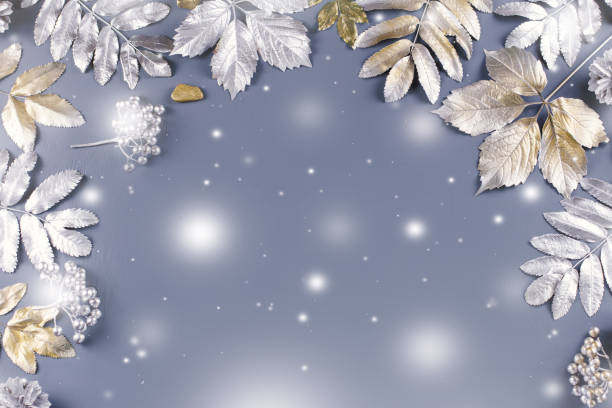 istock Winter concept flat lay with golden and silver leaves. Christmas frame background 1057634404