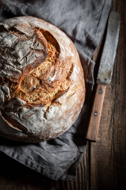 istock Homemade loaf of bread in dark kitchen 1057635742