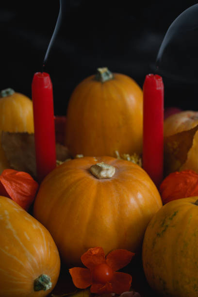 istock Halloween thanksgiving autumn composition pumpkins apples candles smoke 1057635794