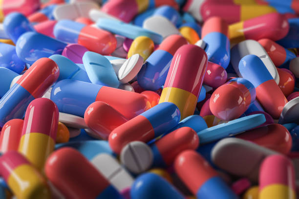 istock Colorful types of pills lying on flat surface 1057638358
