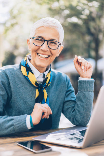 istock Smiling Senior Woman Working on Laptop 1057638802