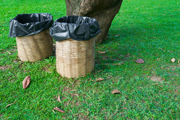 istock Trash bin made of bamboo baskets on green grass at park 1057640398