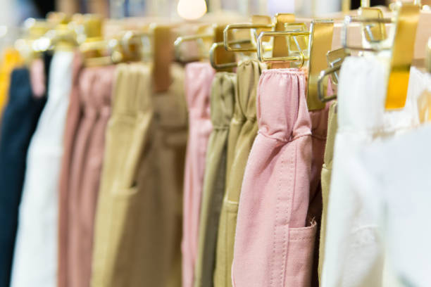 istock Hanger gold clothes with many pastel trousers. 1057641592