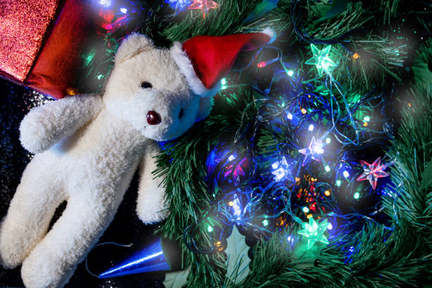 istock Christmas lights and decoration by Santa teddy bear top view camera angle. 1057647044