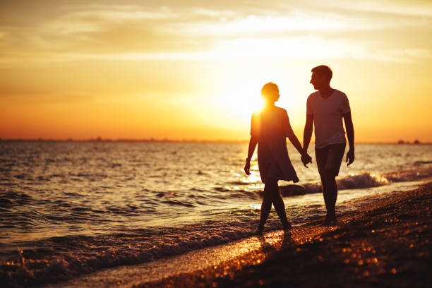 istock Young happy couple on seashore. 1057653940