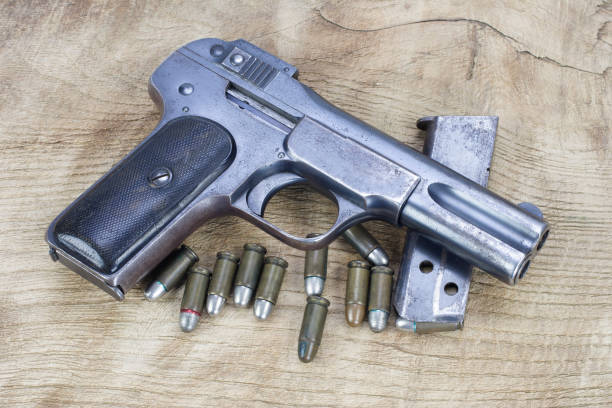 istock Old rusty handgun on wooden background 1057659654