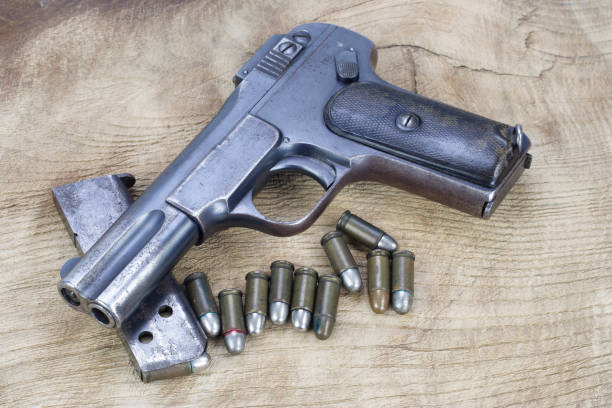 istock Old rusty handgun on wooden background 1057660166