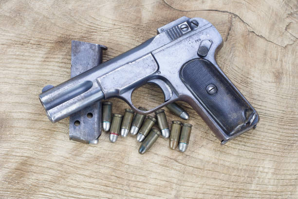 istock Old rusty handgun on wooden background 1057661954