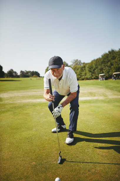 istock Senior golfer checking a golf green before putting 1057662412