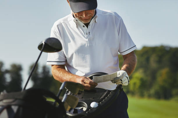 Senior man reading his scorecard while out playing golf