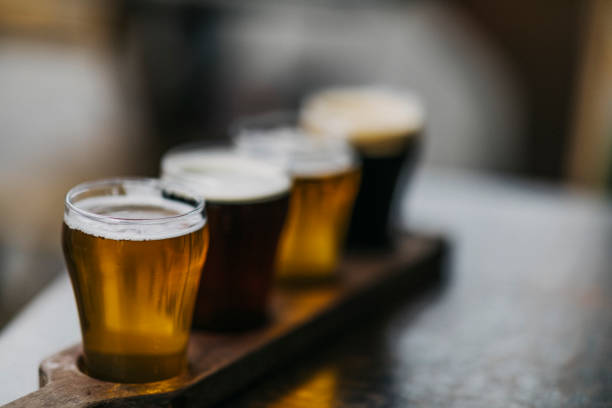Close-up shot of a variety of beers, also known as a beer flight, as served in a microbrewery. stock photo