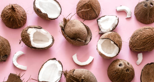 istock Coconut halves on pink background 1057666420