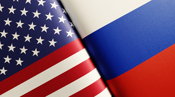 American and Russian flag pair. Horizontal composition with copy space and selective focus.