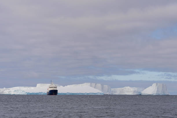 istock Expedition ship with iceberg in Antarctic sea 1057667966