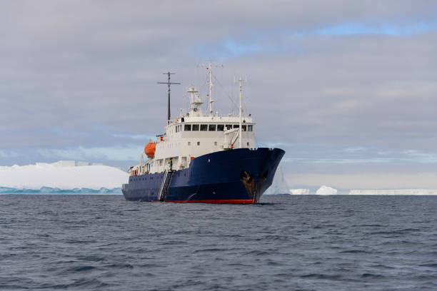 istock Expedition ship with iceberg in Antarctic sea 1057667984