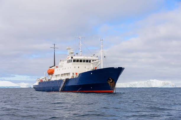 istock Expedition ship with iceberg in Antarctic sea 1057667992