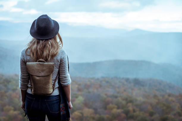 Young woman hiking through beautiful mountains. stock photo