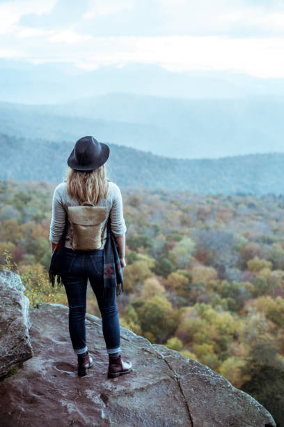istock Young woman hiking through beautiful mountains. 1057668510