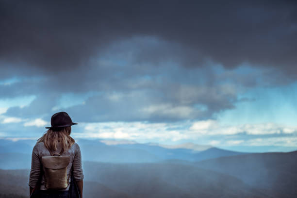 istock Young woman hiking through beautiful mountains. 1057668516
