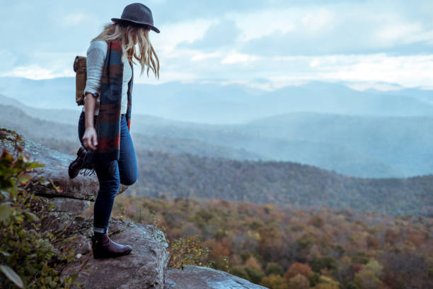 istock Young woman hiking through beautiful mountains. 1057668518