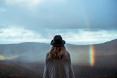 Young woman hiking through beautiful mountains.