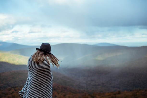 istock Young woman hiking through beautiful mountains. 1057668564