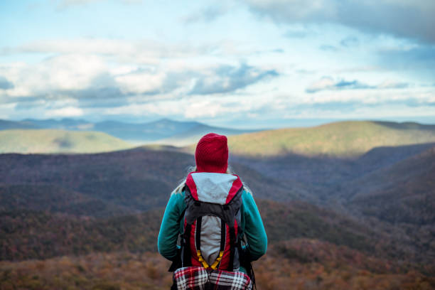 istock Young woman hiking through beautiful mountains. 1057668598