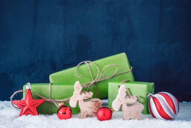 istock Green Christmas Gifts, Snow, Copy Space, Blue Background 1057675946
