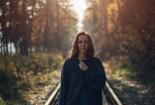 Woman walking on autumnal railways
