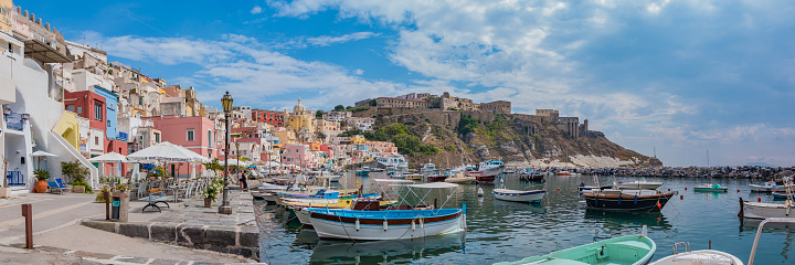 A panorama picture of the Marina della Corricella, the colorful promenade in Procida, Naples.