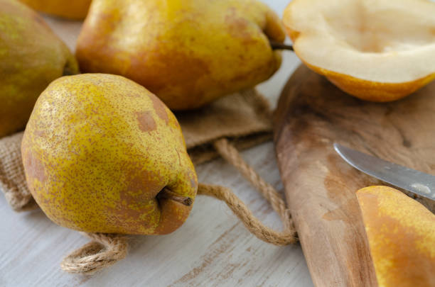 Autumn harvest concept - Vegetarian, vegan, healthy diet food. Selective focus. Fresh ripe organic yellow pears  on the table.