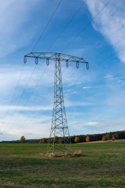 Electricity pylon on a field in autumn