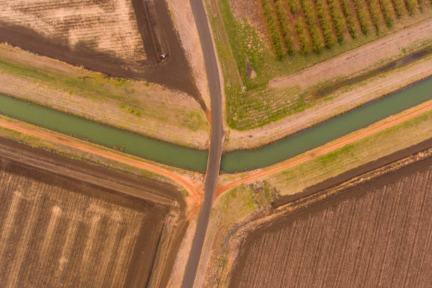 istock Ploughed field in Emerald Central Queensland with water channel running through it, 1057695000