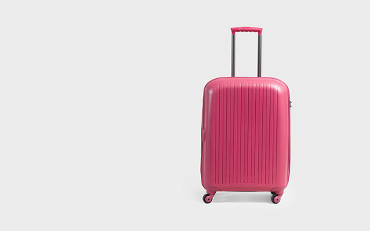 Pink trolley suitcase isolated on white background