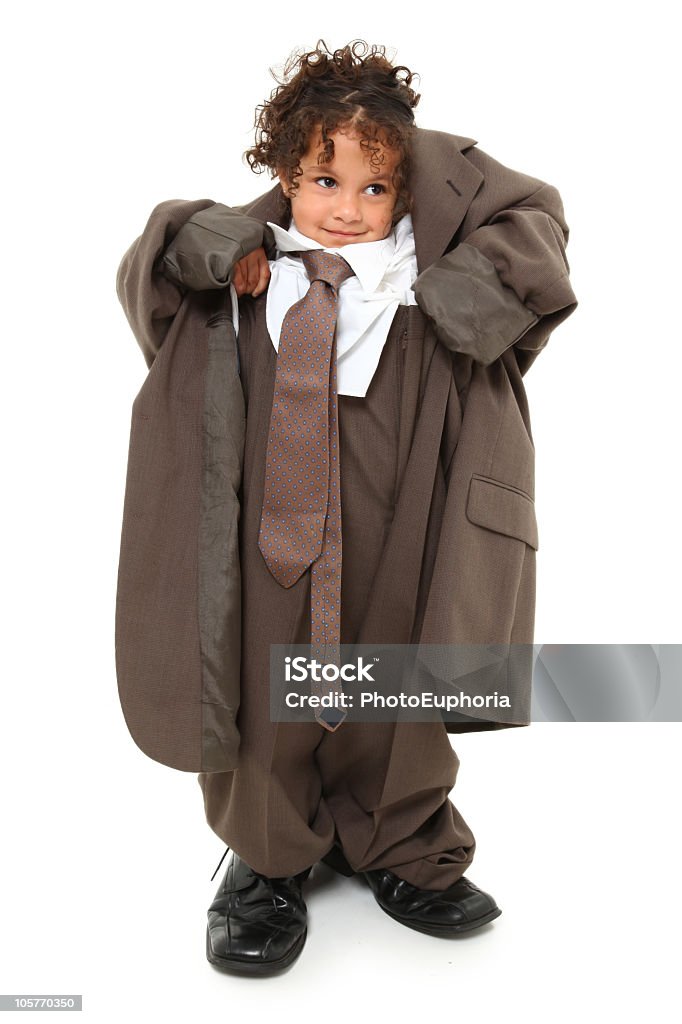 Little girl wearing grown up man's business suit Adorable 3 year old mixed race girl in over-sized baggy suit over white background. Too Big Stock Photo
