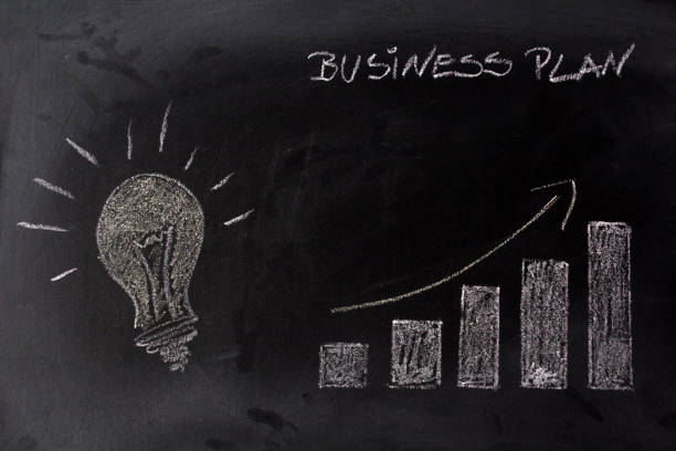 istock Lamp and growing graph on blackboard. Successful idea concept 1057708774