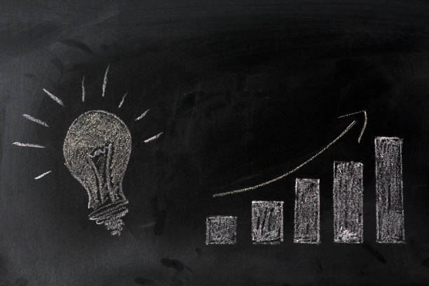 istock Lamp and growing graph on blackboard. Successful idea concept 1057708778