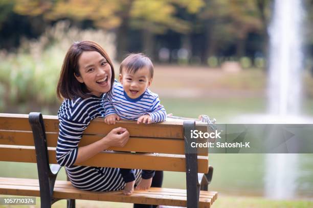 Young Mother And Son Looking At Camera In Public Park Stock Photo - Download Image Now