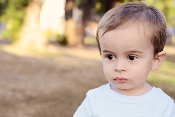 istock Cute one year old baby boy on the park 1057714422