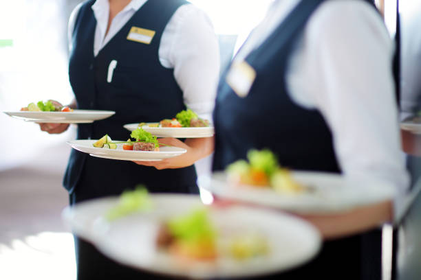 istock Waiter carrying plates with meat dish on some festive event 1057714566